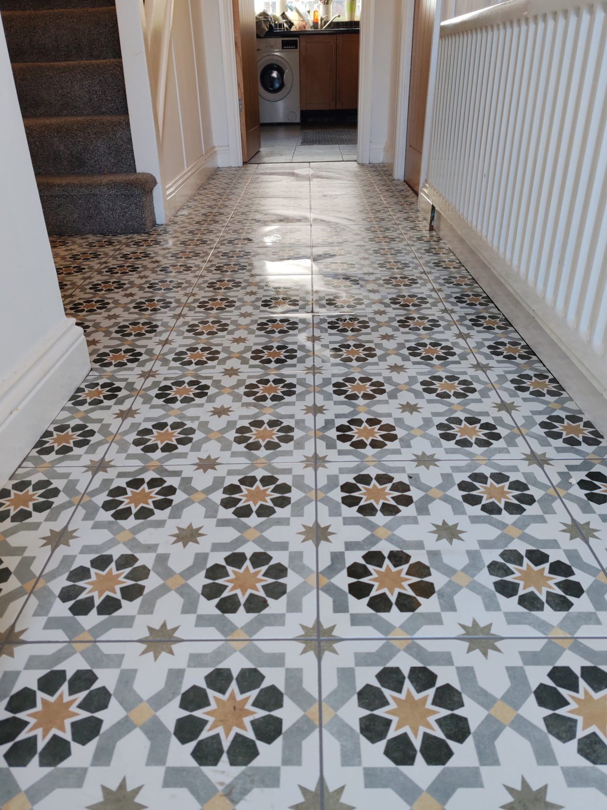 Hallway floor tiled in a patterned star design