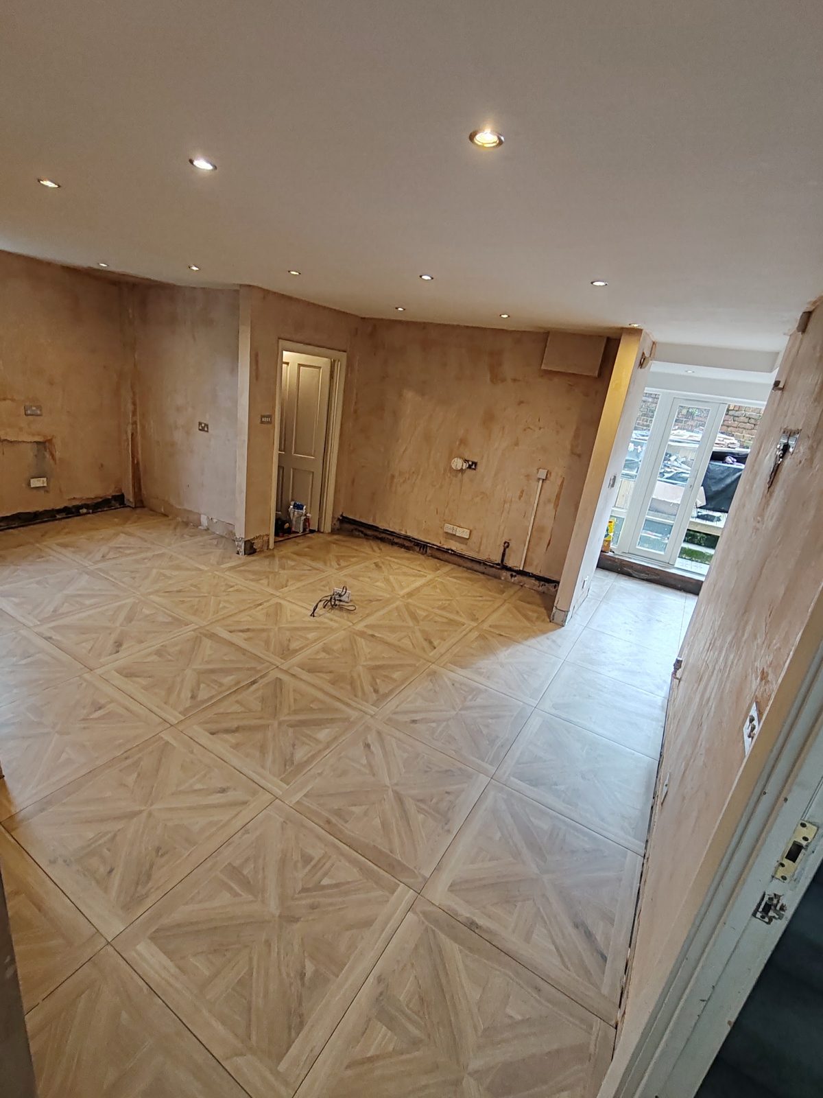 A whole downstairs floor laid in large parquet-effect tiles